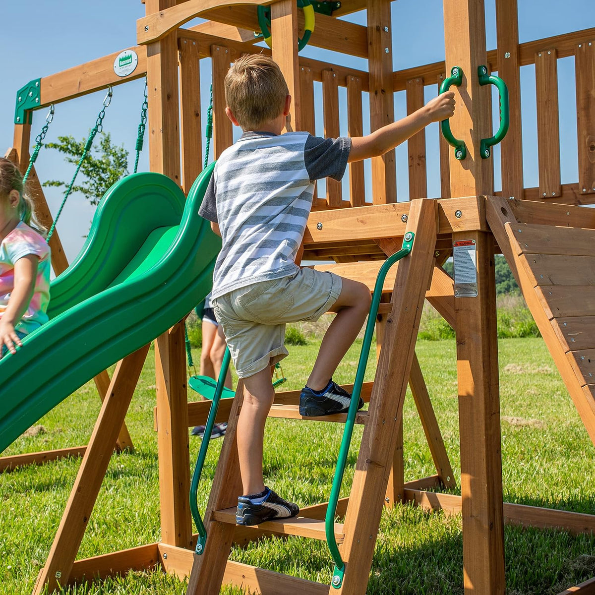 A complete set of wooden mountain-style swings. equipped with a colorful canvas sunshade. a wave slide. a rope swing. a net swing. and a rock wall with climbing ropes and ladders.
