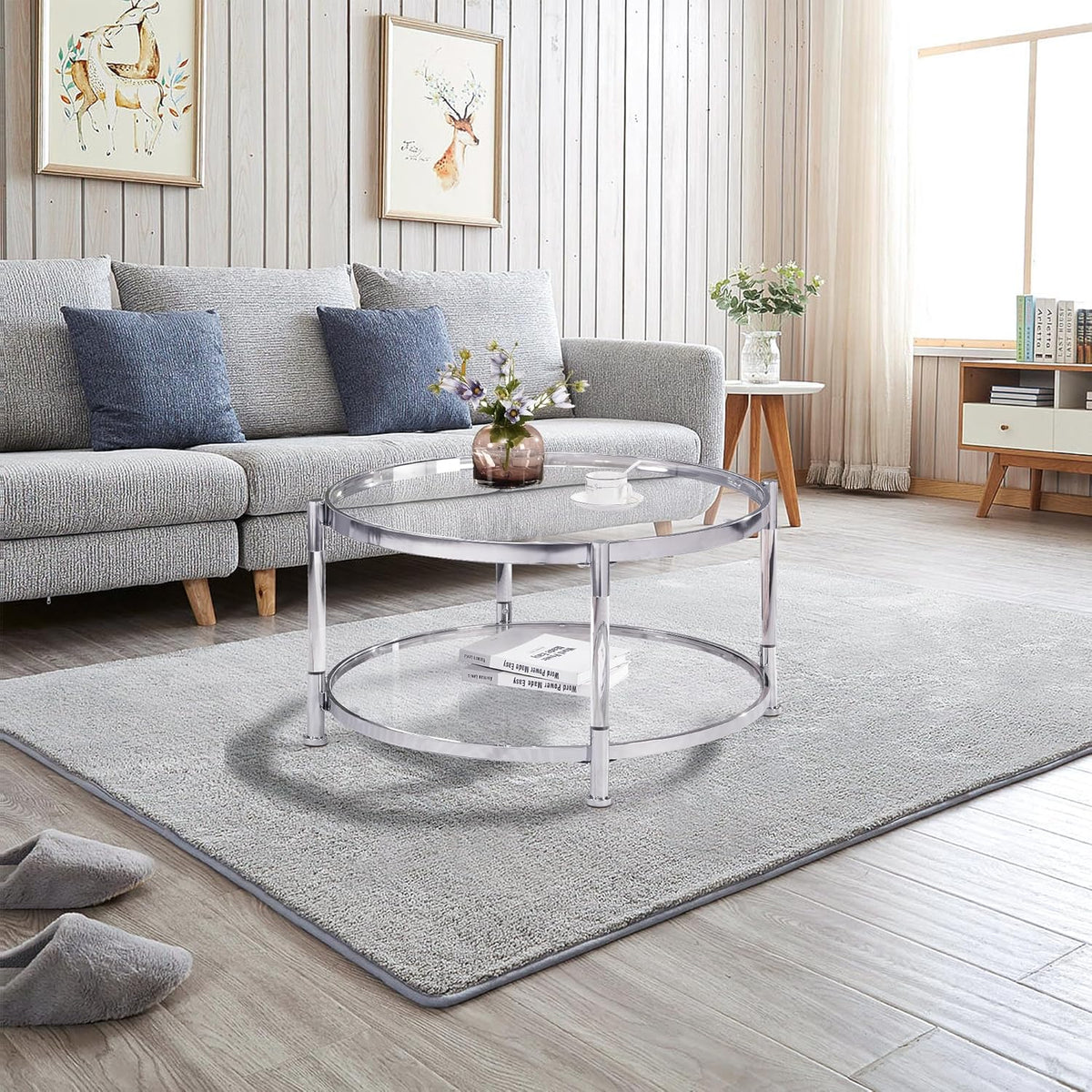 A round coffee table with a metal frame. the surface is made of chrome-plated acrylic glass.