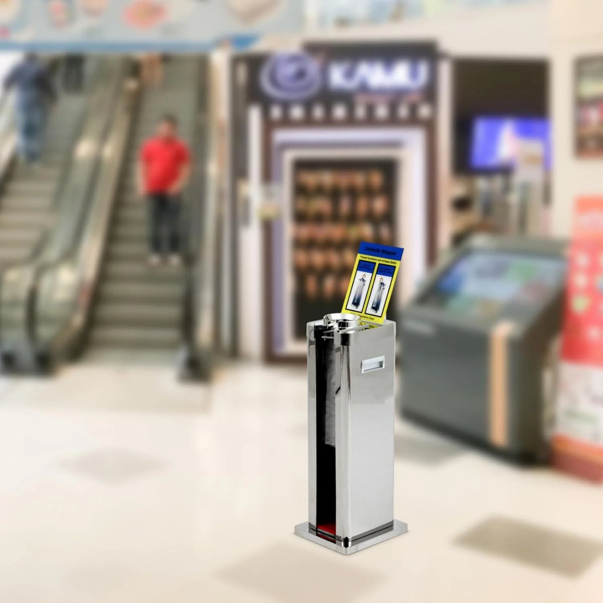 Automatic wet umbrella packaging machine. stainless steel single-slot umbrella bag distributor bracket. equipped with 1000 long umbrella bags and warning signs. suitable for commercial shopping centers. hotels. in silver color.