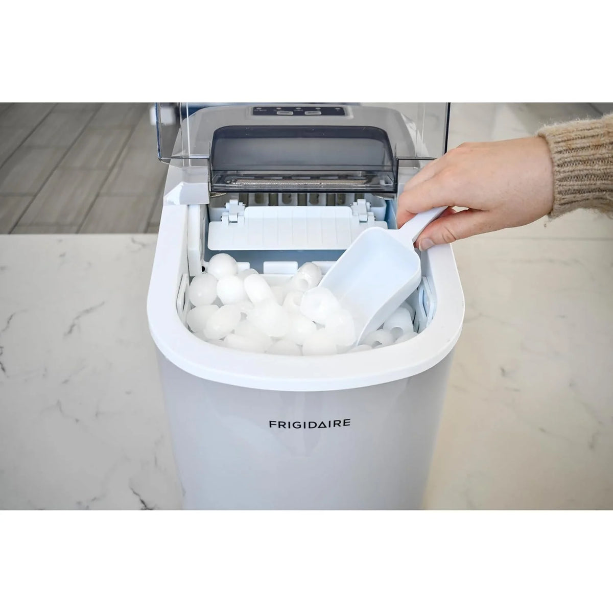 Compact desktop ice machine. capable of producing 26 pounds of ice per day. black color