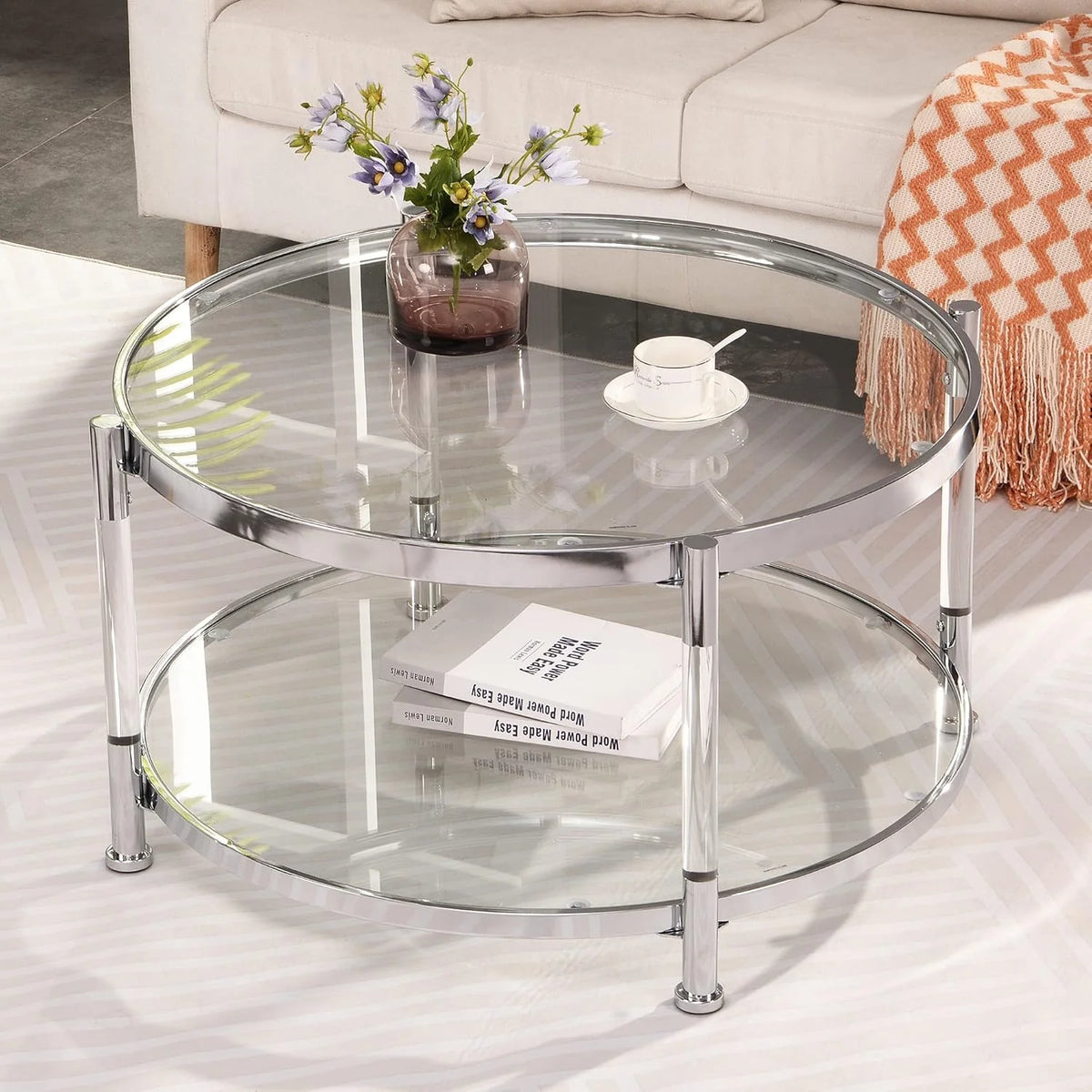 A round coffee table with a metal frame. the surface is made of chrome-plated acrylic glass.
