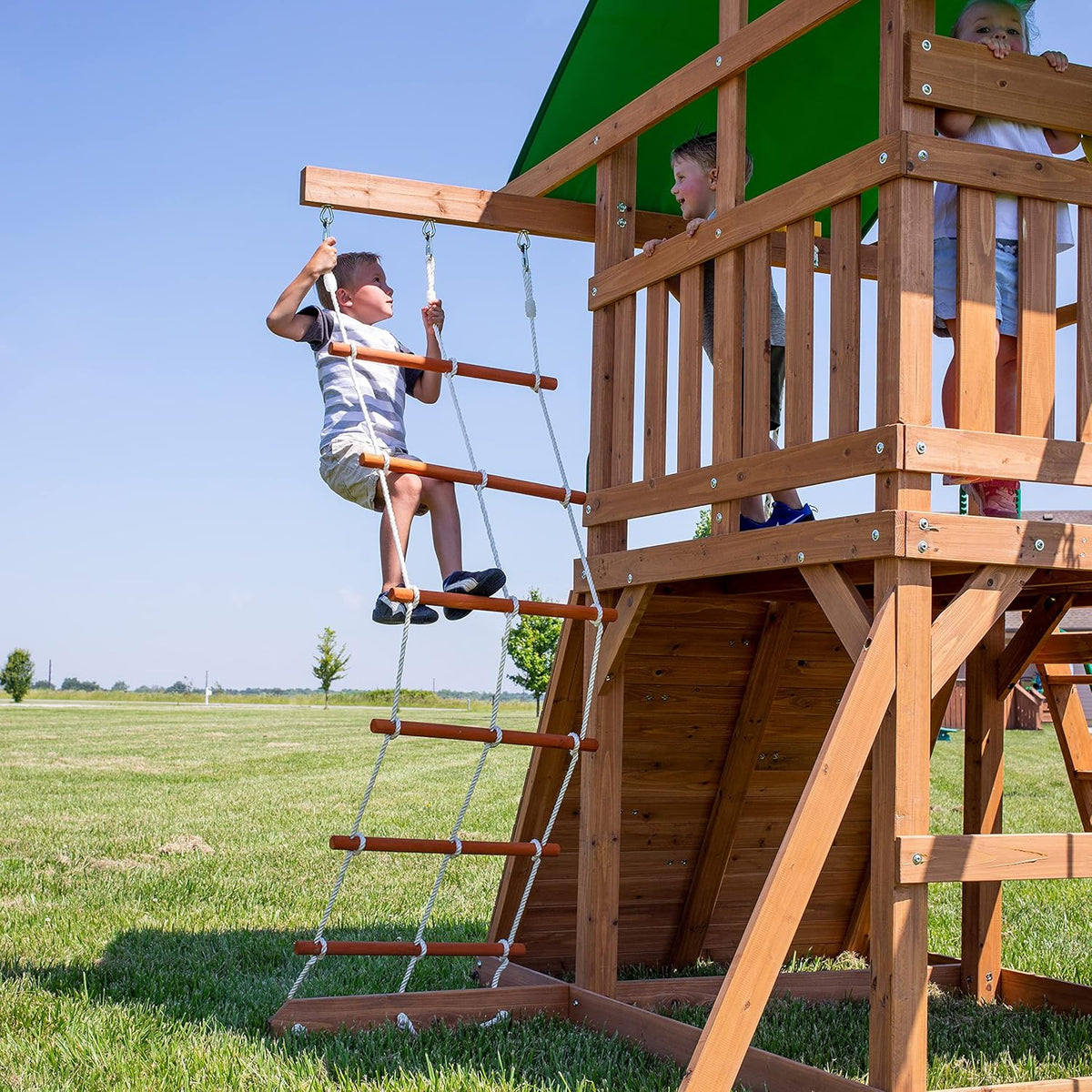 A complete set of wooden mountain-style swings. equipped with a colorful canvas sunshade. a wave slide. a rope swing. a net swing. and a rock wall with climbing ropes and ladders.