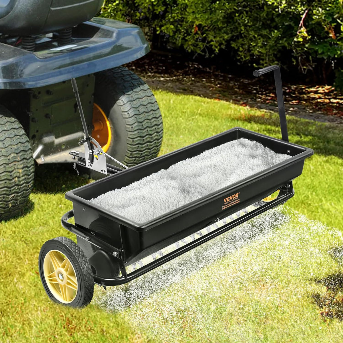 Broadcast seeder. 100-pound tractor-mounted rear polyethylene seeder with 10-inch wheels. equipped with a steel spike weeder. fertilizer spreader. garden seeder and salt spreader. suitable for residences. farms. rough terrain. and black pavement.