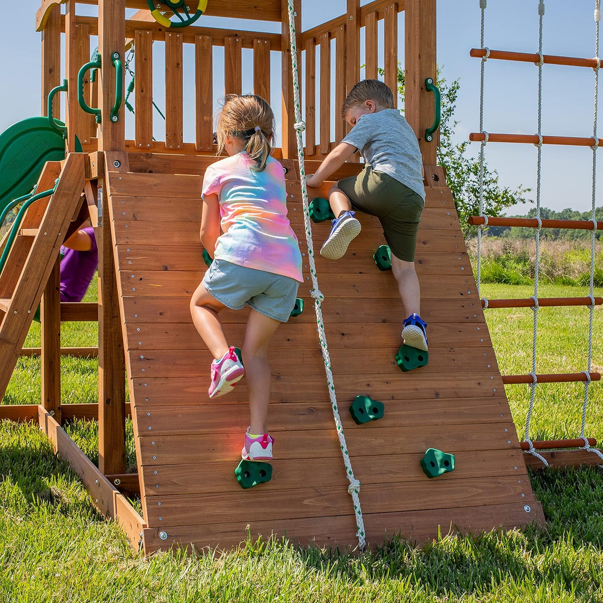 A complete set of wooden mountain-style swings. equipped with a colorful canvas sunshade. a wave slide. a rope swing. a net swing. and a rock wall with climbing ropes and ladders.